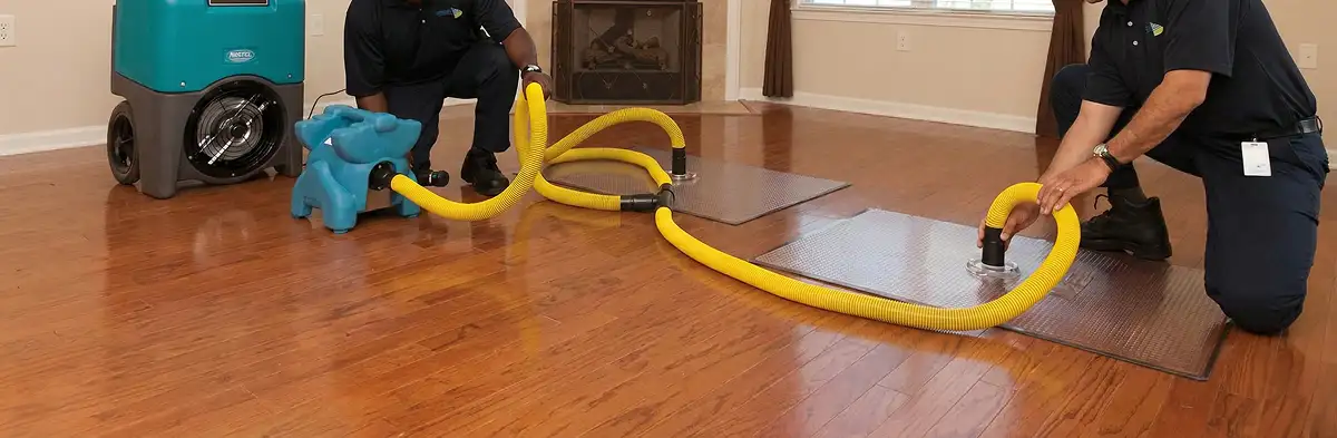emergency water removal technicians extracting standing water from a home using professional equipment in Omaha, NE